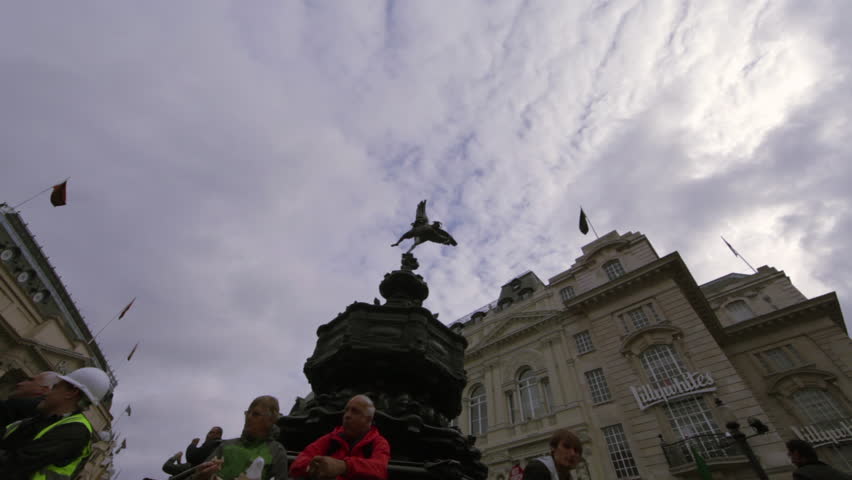 LONDON - OCTOBER 7, 2011: Unidentified people sit on the steps of the Eros