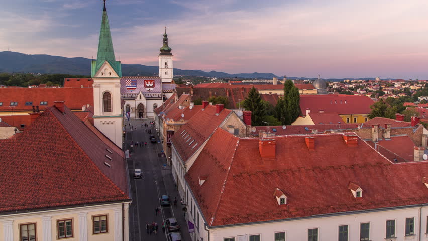 Church of St. Mark day to night transition timelapse and parliament building Zagreb, Croatia. Top view from Kula Lotrscak tower viewpoint after sunset