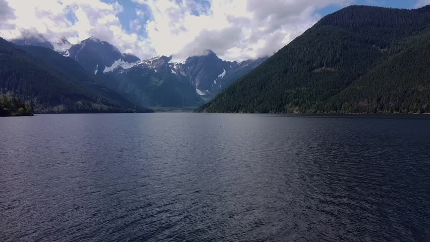 Aerial Drone shoot over a lake with mountain in the background