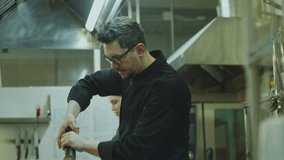 Head chef helping young female apprentice with flambeing food in a skillet while cooking together during workday in restaurant kitchen - Powered by Shutterstock - Get 15% off with code: PIKWIZARD15