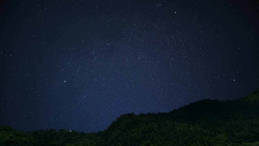 Timelapse of Star trail mountain. Stunning views of the hills under a deep blue starry night sky.
