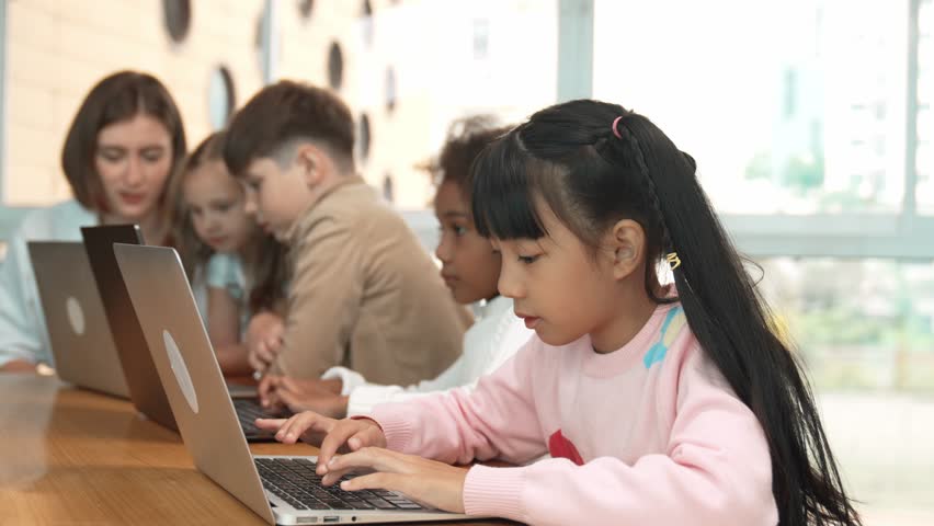 Group of multiethnic children working or playing laptop, programing system. Happy funny diverse student working by using laptop to writing prompt or programing system. Smart classroom. Erudition. - Powered by Shutterstock - Get 15% off with code: PIKWIZARD15