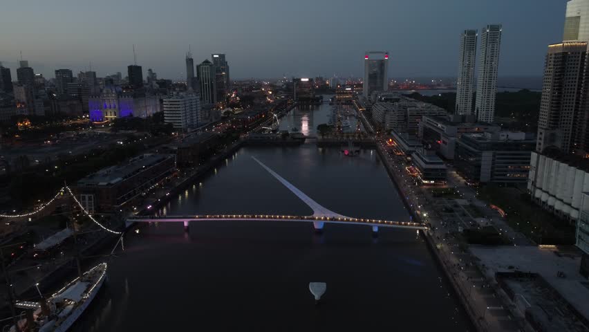 Puerto Madero-Puente de la Mujer Footbridge Woman-Madero Harbor-Buenos Aires at Sunset-City Buildings Night Lights-Argentina-Ciudad de Buenos Aires at Sunset - Argentina - Aerial Drone Scene