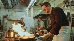 Skilled chef using blow torch while cooking food in pan in burning fire flames during workday in restaurant kitchen - Powered by Shutterstock - Get 15% off with code: PIKWIZARD15