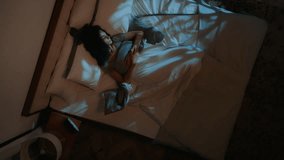 Top view woman sleeping in bed night time insomnia bad sleep discomfort napping in bedroom sleepy African American girl female angry awake hear sound of alarm clock waking up annoyed nap deprivation - Powered by Shutterstock - Get 15% off with code: PIKWIZARD15