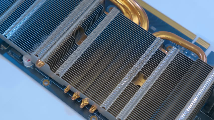 Powerful radiator with copper tubes for circulating coolant to cool the computer video card. Closeup. Macro. Shallow depth of field. Shot in motion 