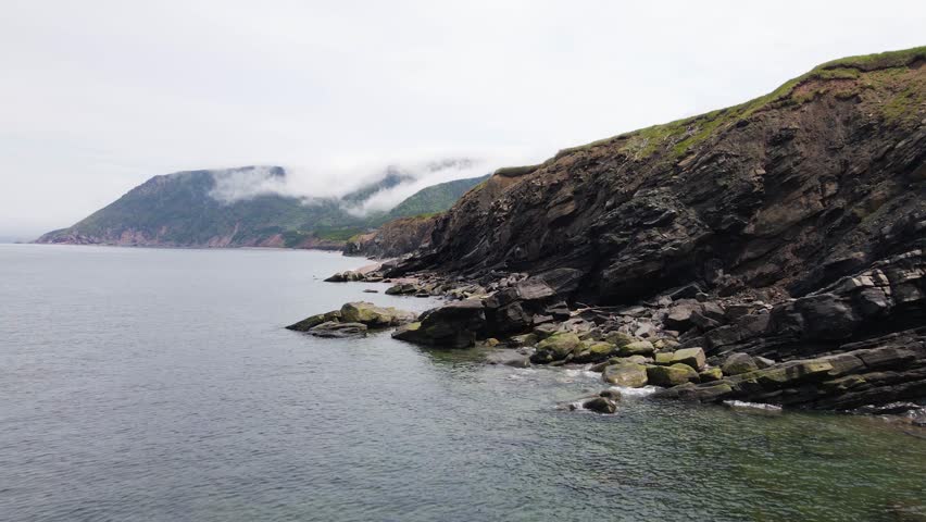 Drone shot of the rugged and beautiful coastline of the Cape Breton Island highlands national park during a windy summer day shot in 4k in Nova Scotia, Canada.