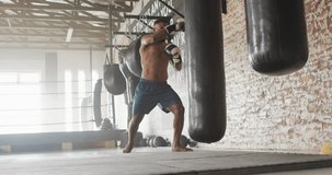 Video of fit african american man boxing at gym. active, fit, sporty and healthy lifestyle, exercising at gym concept.
