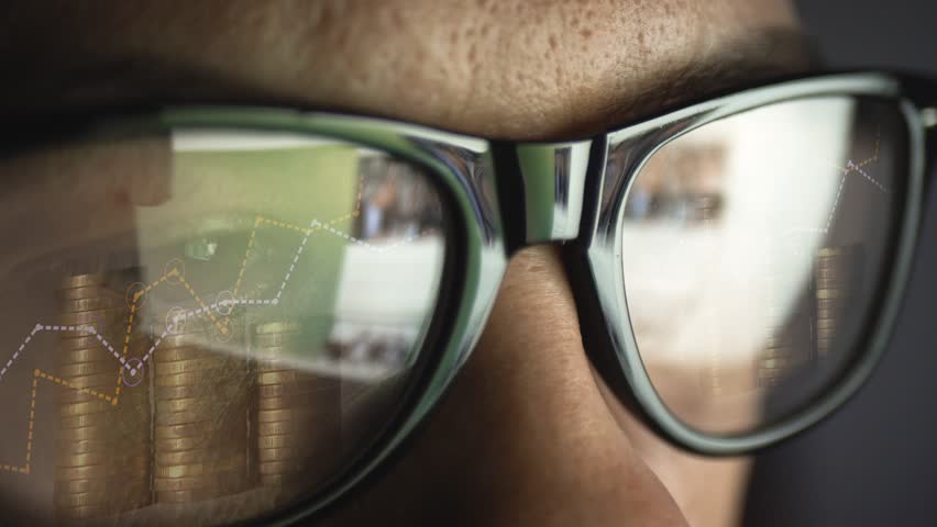 In the reflection of glasses on a man's face, surfing the Internet and growing graphs and a diagram of increasing coins. Business and finance. Inflation and rising prices. Cg