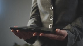 Turquoise gears with a flickering hologram effect over a digital tablet in the hands of a businesswoman. The concept of creating a new project. Cg footage - Powered by Shutterstock - Get 15% off with code: PIKWIZARD15