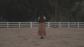 Woman walking on farmland, stock video