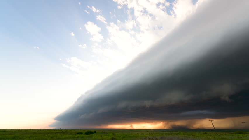 Shelf cloud approaches, packed with wind, rain, and a beautiful sunset. Royalty-Free Stock Footage #3469259417
