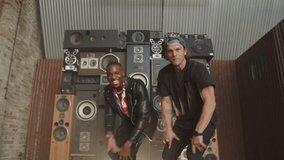 Bros rapping together in front of speakers