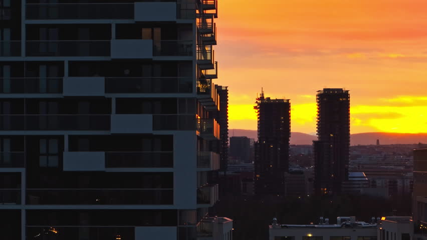 Aerial view of the river in the cityscape of Vienna, Austria. Silhouettes of high-rise buildings in the urban landscape of the sunset in the capital. High quality 4k footage