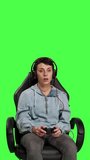 Front view Furious displeased gamer losing video games multiplayer tournament with her friends on online connection, greenscreen backdrop. Angry woman lost shooter competition, gaming setup. Camera B.