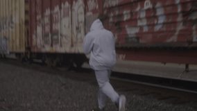 Athlete jogs by train, stock video