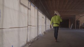 Construction worker carrying boards, stock video