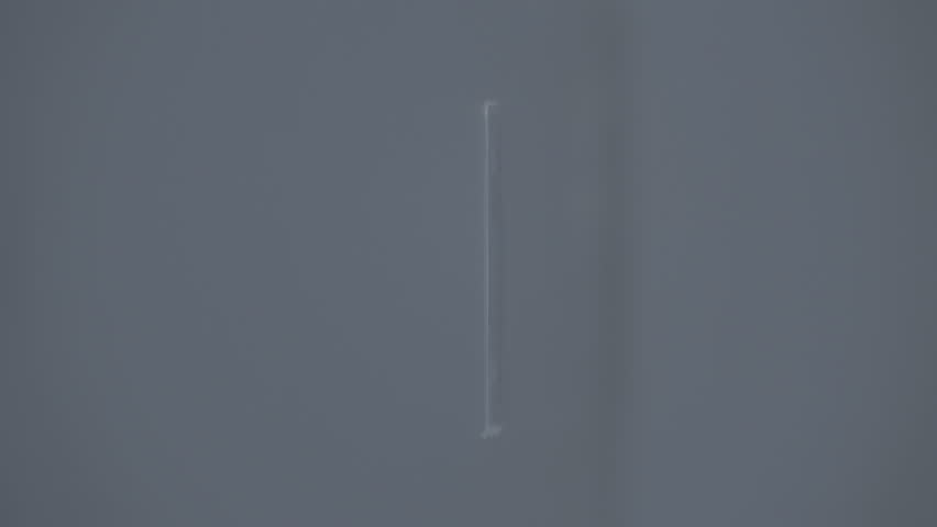 Male fingers inserting a quarter dollar coin into a coin receiver, the light is brightly reflected from the surface of the coin. Closeup. Macro. Slow mo, slo mo, slow motion, high speed camera, 250fps