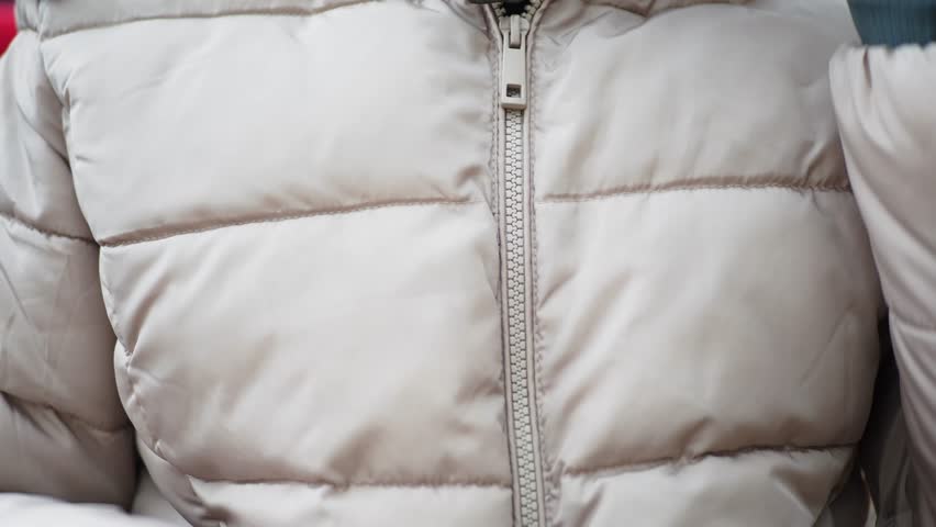 woman zipper on a jacket in cold autumn day. 