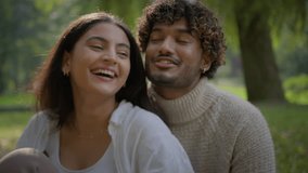 Happy multiracial couple in love man woman enjoying communication talk laughing romantic date outdoors in nature Indian Arabian boyfriend girlfriend guy girl hugging speak together affection in park - Powered by Shutterstock - Get 15% off with code: PIKWIZARD15