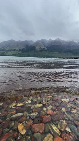 Slow motion video of Beautiful landscape views at Glenorchy marina with mountain ranges at the background 