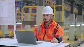 The engineer using laptop and take a video conferance in the railway garage. engaged in tasks such as inventory management, order internet or logistical operations.