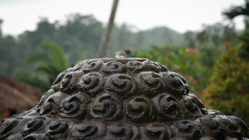 God head fountain sculpture in the middle of the hotel garden with the jungle in the back. Bali, Indonesia. High quality FullHD slow motion footage.
