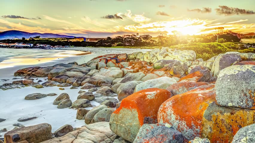White sandy beach and orange lichen in The Gardens, Bay of Fires consevation Area ranging from Binalong Bay to Eddystone Point, east coast of Tasmania in Australia. Cinemagraph.