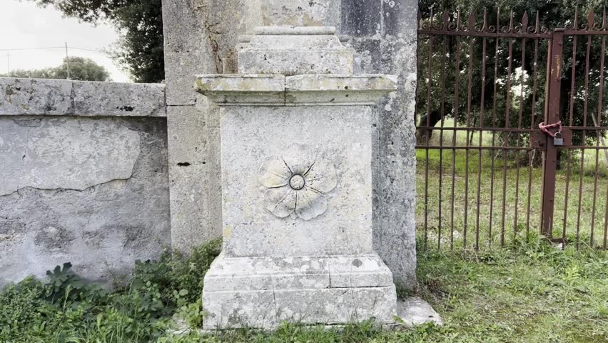 Mammalocchi statue travertine column with allegorical figures standing at entrance to private villa in Umbria, Italy. Tilt-up