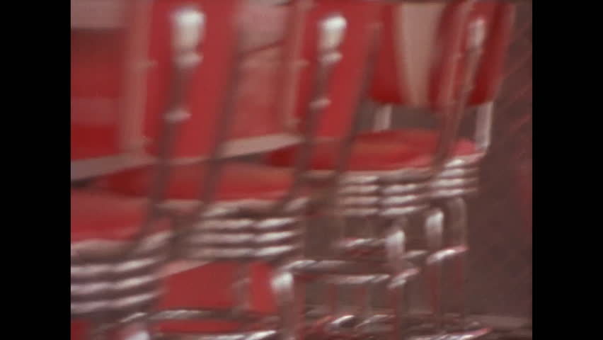 Vintage film of bar stools in an empty diner Royalty-Free Stock Footage #3469544249