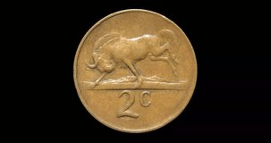 Reverse of South Africa coin 2 cents 1965, isolated in black background. Loopable animation in 4k resolution video.