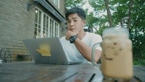 Young adult asian man sit down under trees working with laptop, type down on computer keyboard, paperless soft files transfer, online transactions, new creative ideas while working outdoor alone - Powered by Shutterstock - Get 15% off with code: PIKWIZARD15