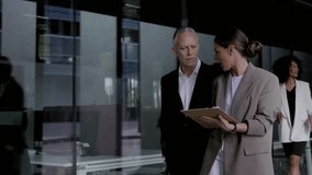 Moving shot diverse business people walking fast through office corridor. Center with formal professional employees active working. Company and workers moving in lobby and hallway.  - Powered by Shutterstock - Get 15% off with code: PIKWIZARD15