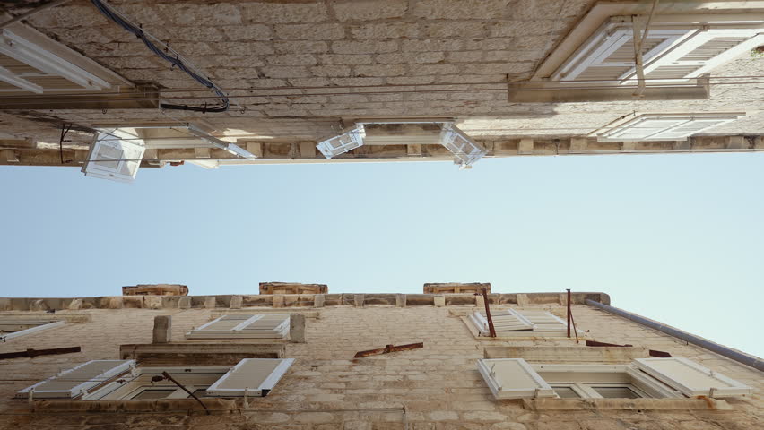Low Angle Gliding Shot Made Between Old Buildings in Dubrovnik, Croatia