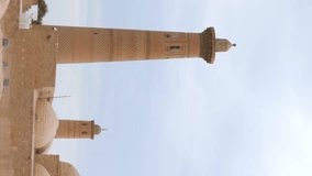 Vertical video footage of the minaret towers over the buildings of the ancient city of Ichan-Kala, Khive, Uzbekistan