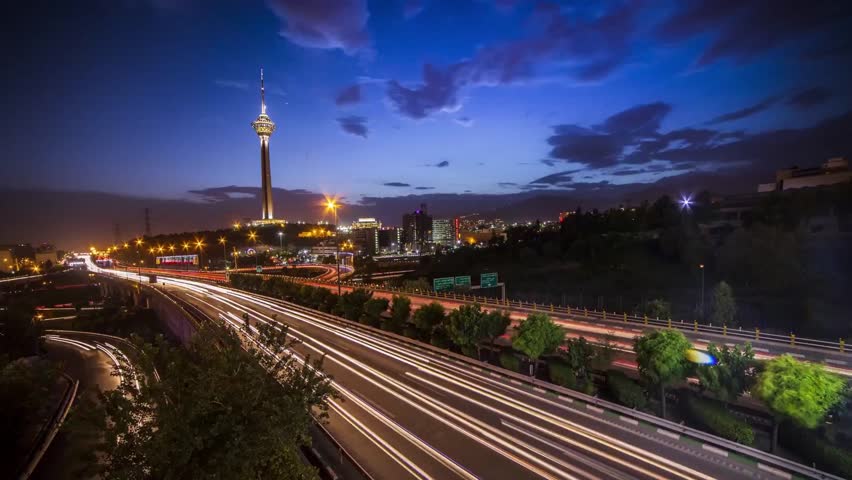 Time Lapse of Milad Tower in Tehran, IRAN - Time Lapse of The Road Opposite Milad Tower in Tehran, IRAN - Time Lapse of Milad Tower in Tehran, IRAN IN A CLOUDY DAY Royalty-Free Stock Footage #3469688261