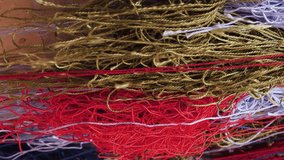 Vertical video footage of yarn, threads for making carpets in the traditional manual way. Multi-colored skeins of thread are sold at a bazaar in the city of Khiva, Uzbekistan - Powered by Shutterstock - Get 15% off with code: PIKWIZARD15