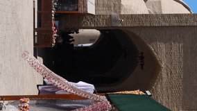 Vertical video footage of on the street of the old city. Trade stalls with traditional fabrics and souvenirs - Powered by Shutterstock - Get 15% off with code: PIKWIZARD15