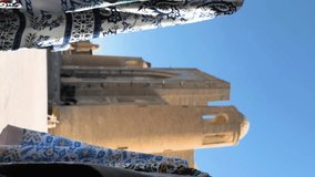 Vertical video footage of trade stalls with traditional textiles and products in the old city of Bukhara, Uzbekistan. Fabric with a national pattern flutters in the wind - Powered by Shutterstock - Get 15% off with code: PIKWIZARD15