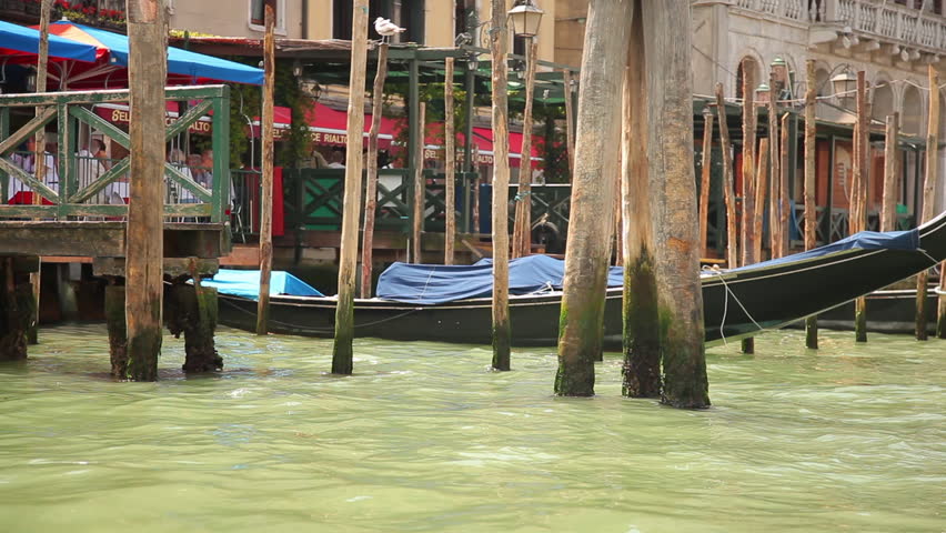 VENICE - MAY 2, 2012: Tracking shot of gondola docks from the water