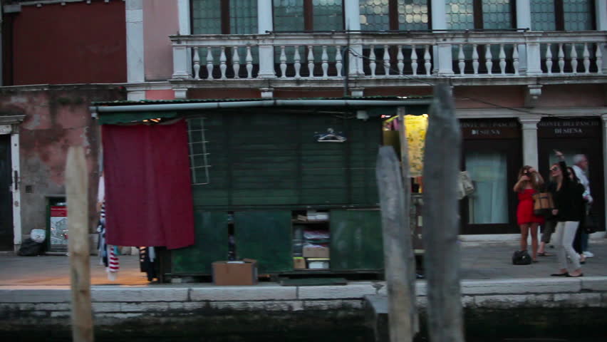 VENICE - MAY 2012: Passing shot of Venetian shops and Restaurants in the