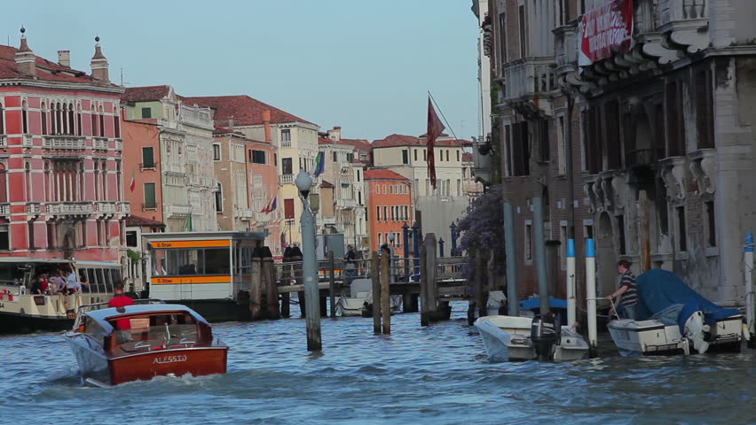 VENICE - MAY 2012: Shot from water taxi. Colorful buildings are visible. Two