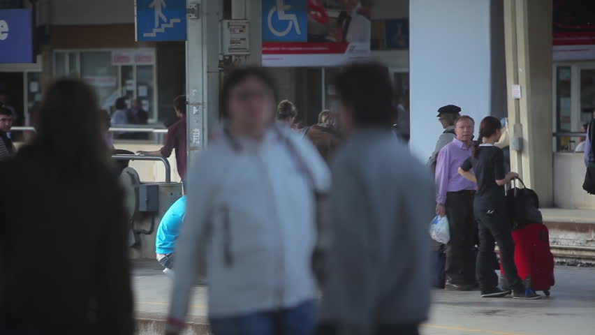 VENICE - MAY 2012: Tracking shot of passengers waiting on a train platform 