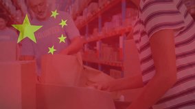Animation of flag of china over diverse male volunteers and woman making donation in warehouse. Chinese, teamwork, business, charity, economy and distribution, digitally generated video.