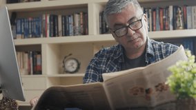 businessman reading newspaper at office - Powered by Shutterstock - Get 15% off with code: PIKWIZARD15