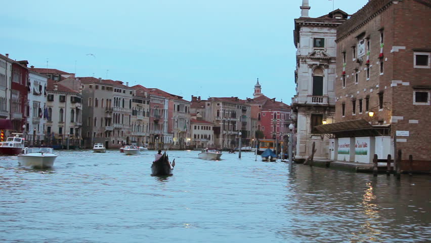 VENICE - MAY 2012: Shot of boats on venetian canal at dusk. Boats and old