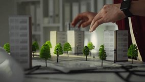 The project architect uses professional skills to carefully select the correct location of buildings. Brainstorming to find the right solution, developing a concept for sustainable city of the future - Powered by Shutterstock - Get 15% off with code: PIKWIZARD15