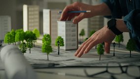 Location of houses in the city of the future, white man using tools actively participates in brainstorming in a work office. Design studio where the concept of sustainable residential area is created - Powered by Shutterstock - Get 15% off with code: PIKWIZARD15