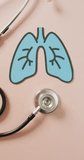 Vertical video of lungs icon and stethoscope on beige background. health, prevention, medicine, symbols and cancer awareness concept.