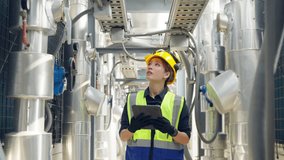 Professional Asian woman engineer in safety uniform working on digital tablet at outdoor construction site rooftop. Industrial technician worker maintenance checking building exterior air HVAC systems - Powered by Shutterstock - Get 15% off with code: PIKWIZARD15